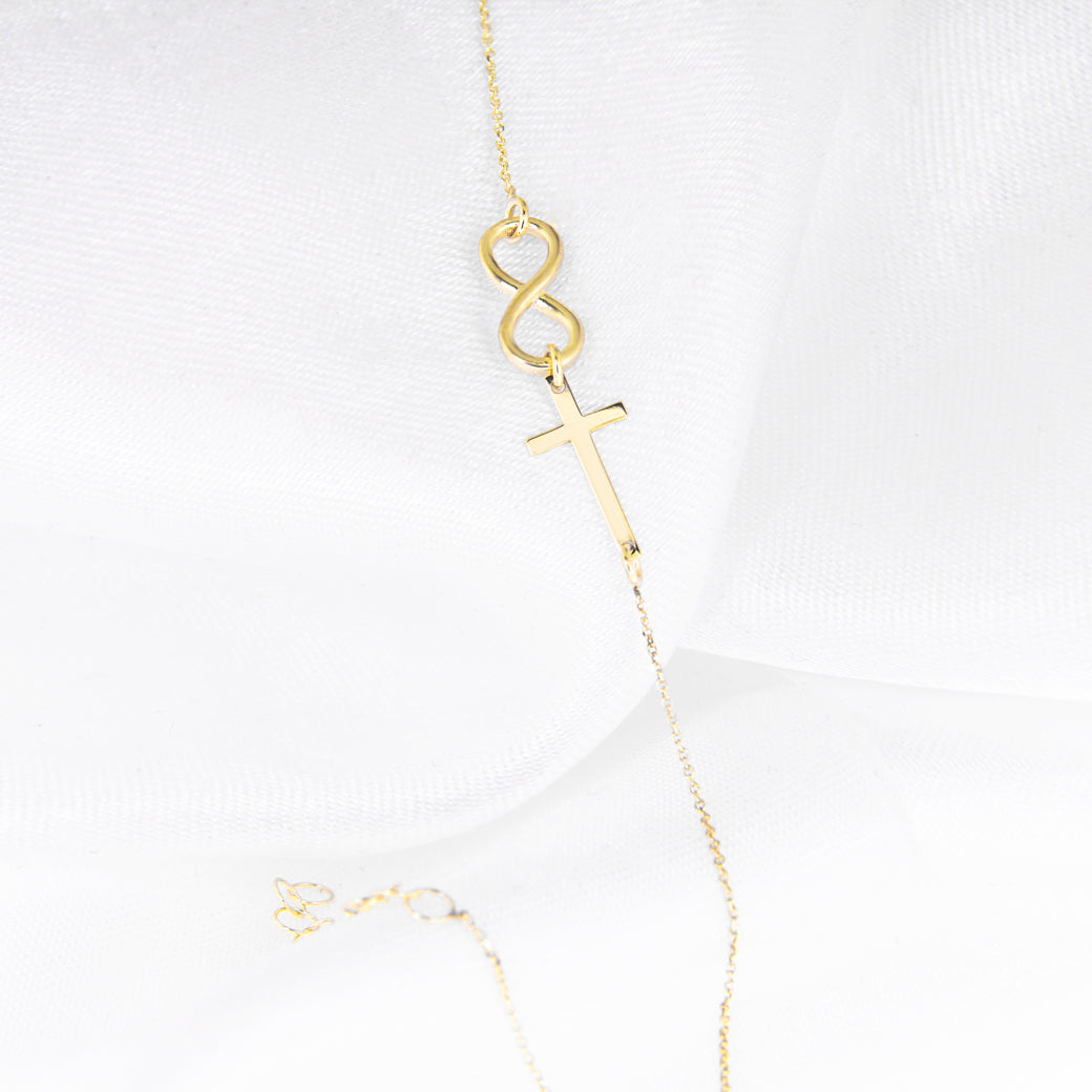 Złota bransoletka z krzyżykiem i nieskończonością